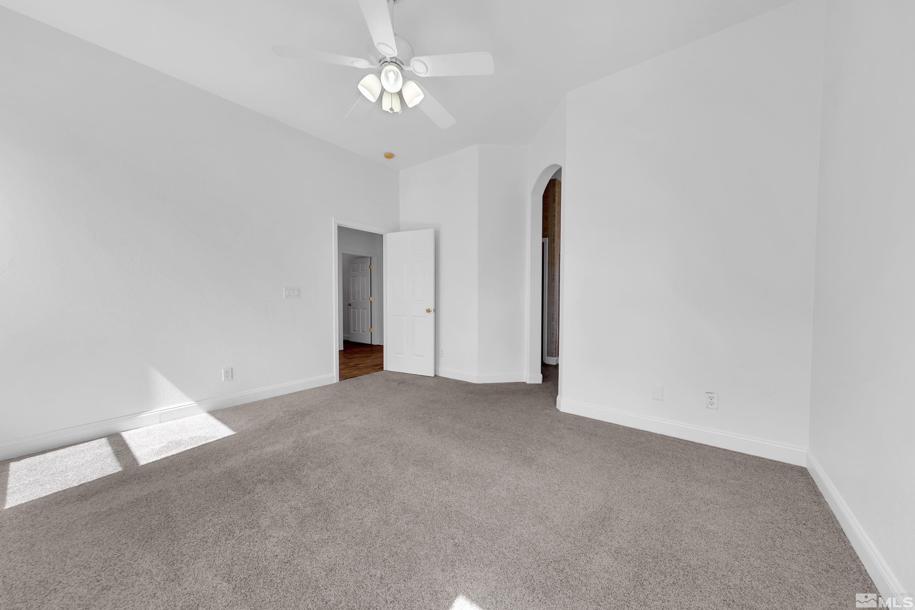10445 Arbor Way Reno, NV 89521 - Photo 25 of 39 an empty room with a ceiling fan and a window