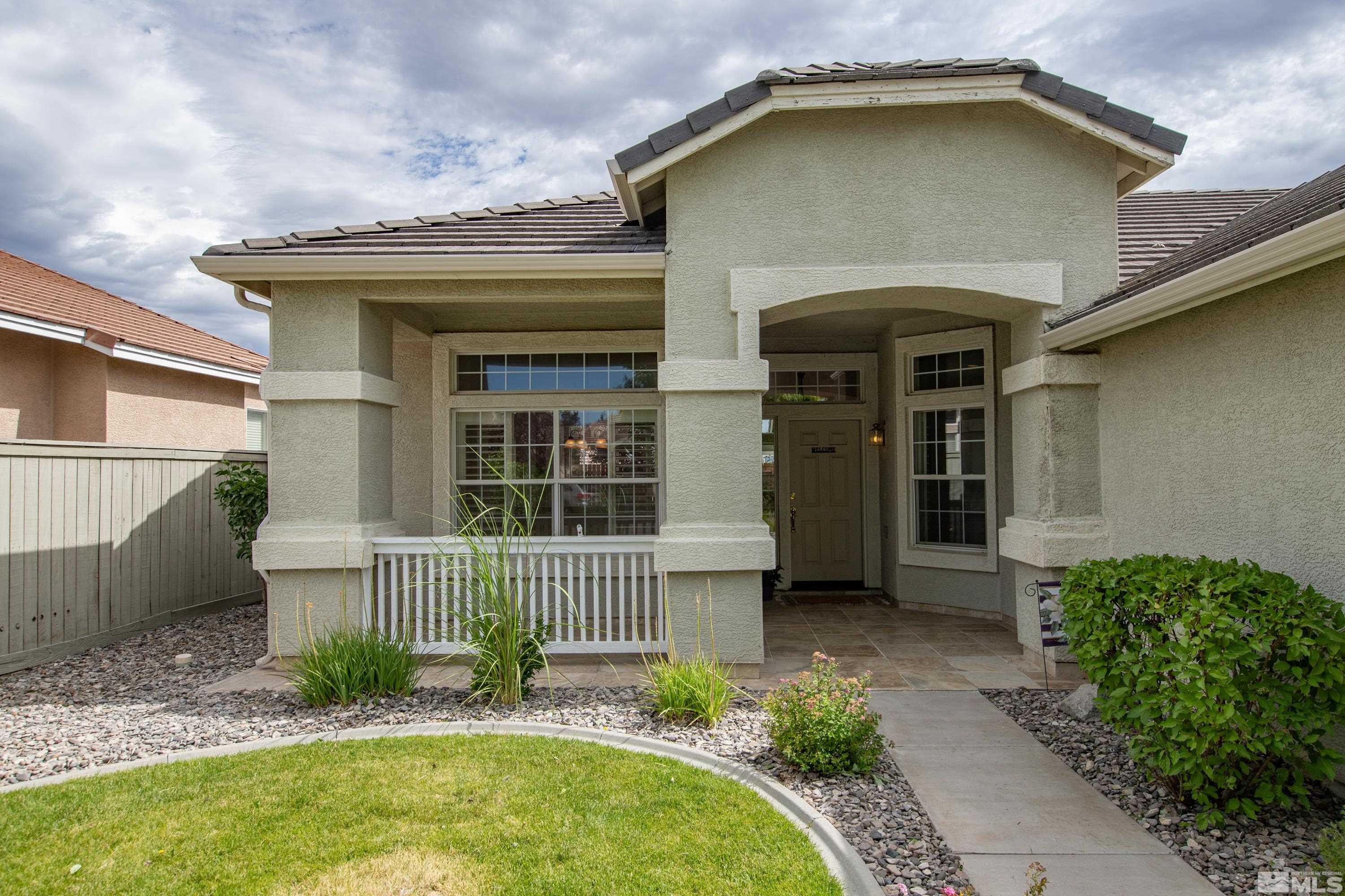 10445 Arbor Way Reno, NV 89521 - Photo 3 of 39 a front view of a house with a yard