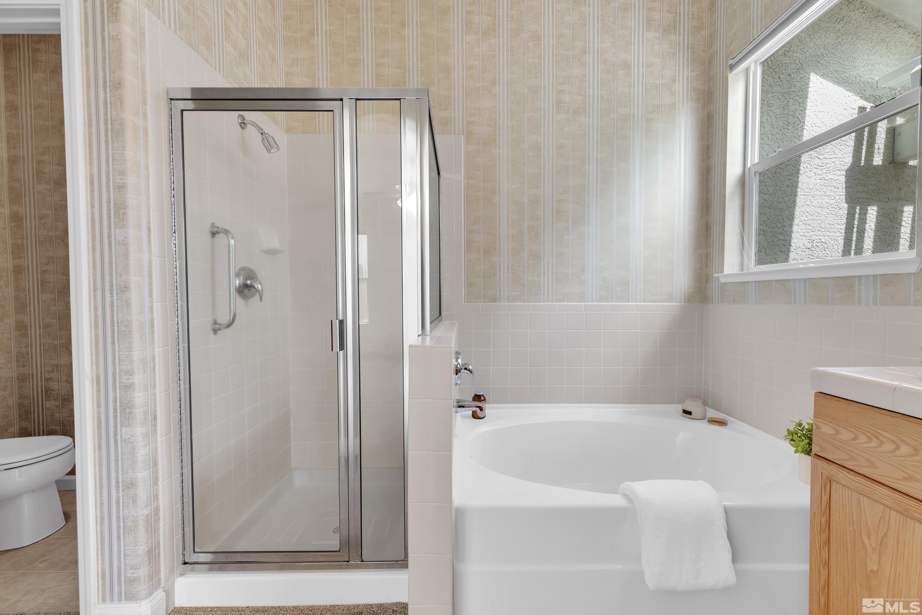 10445 Arbor Way Reno, NV 89521 - Photo 31 of 39 a bathroom with a bathtub and a shower