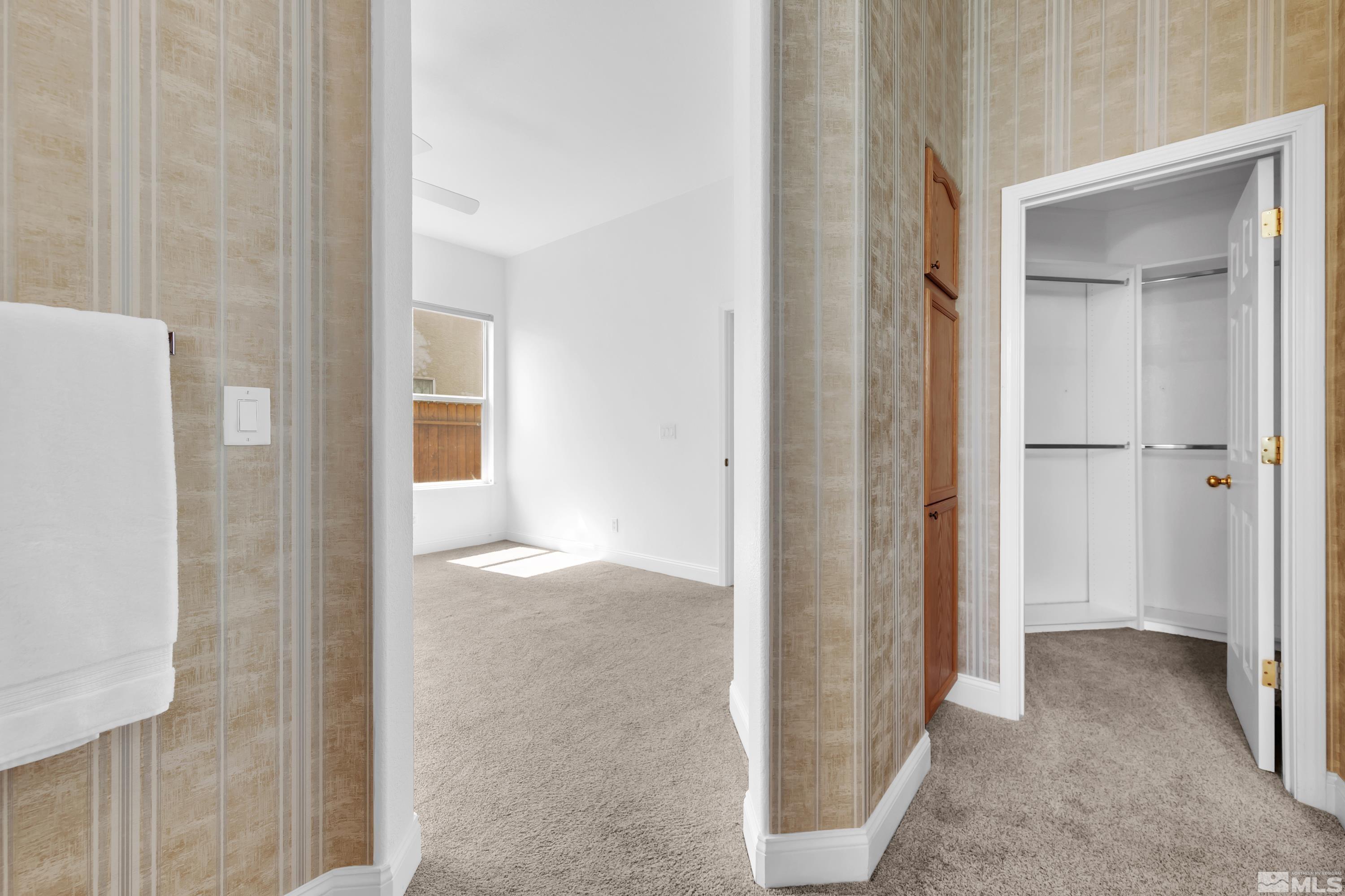10445 Arbor Way Reno, NV 89521 - Photo 32 of 39 a view of a hallway with wooden floor and closet area