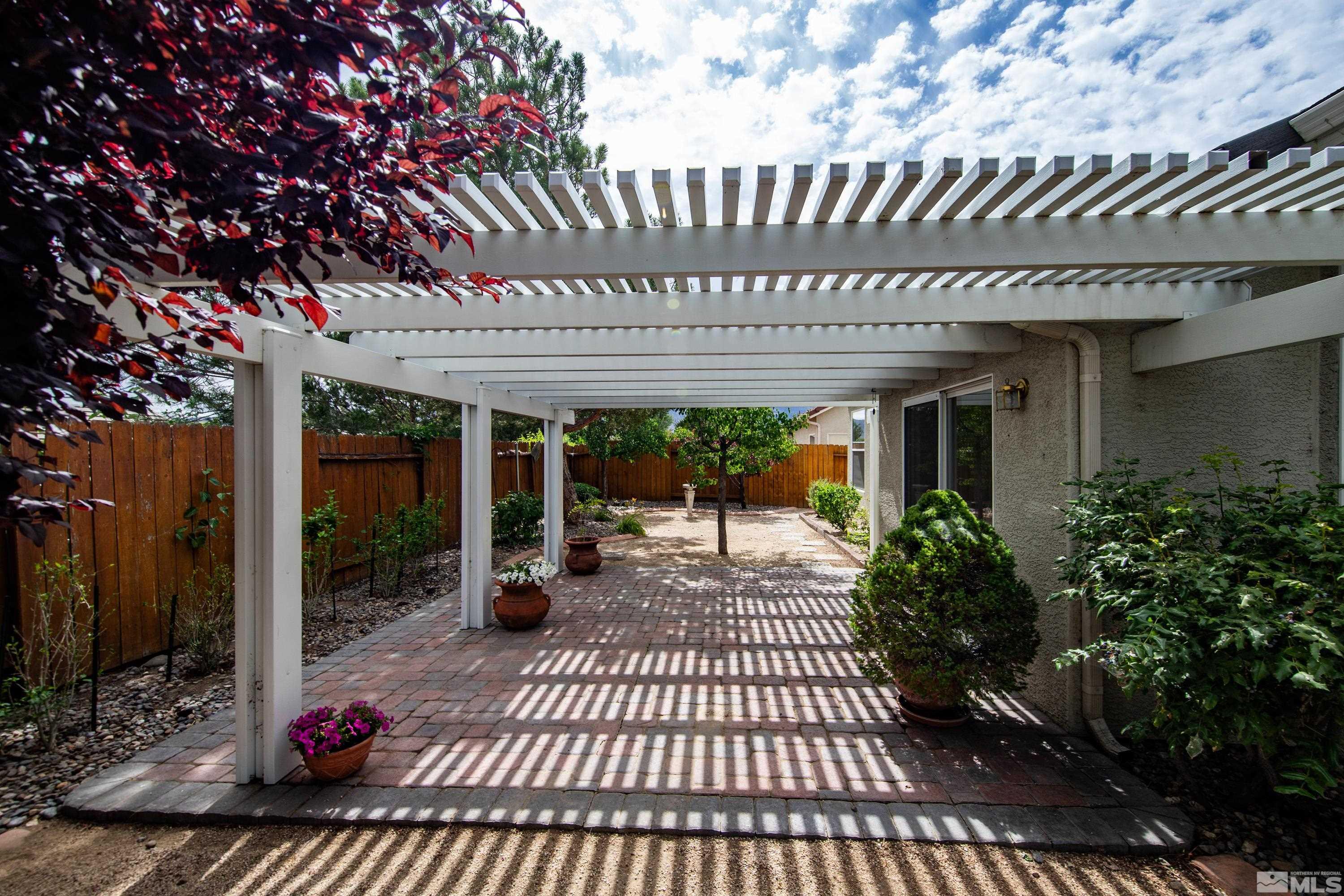 10445 Arbor Way Reno, NV 89521 - Photo 39 of 39 a view of a patio with table and chairs potted plants and large tree