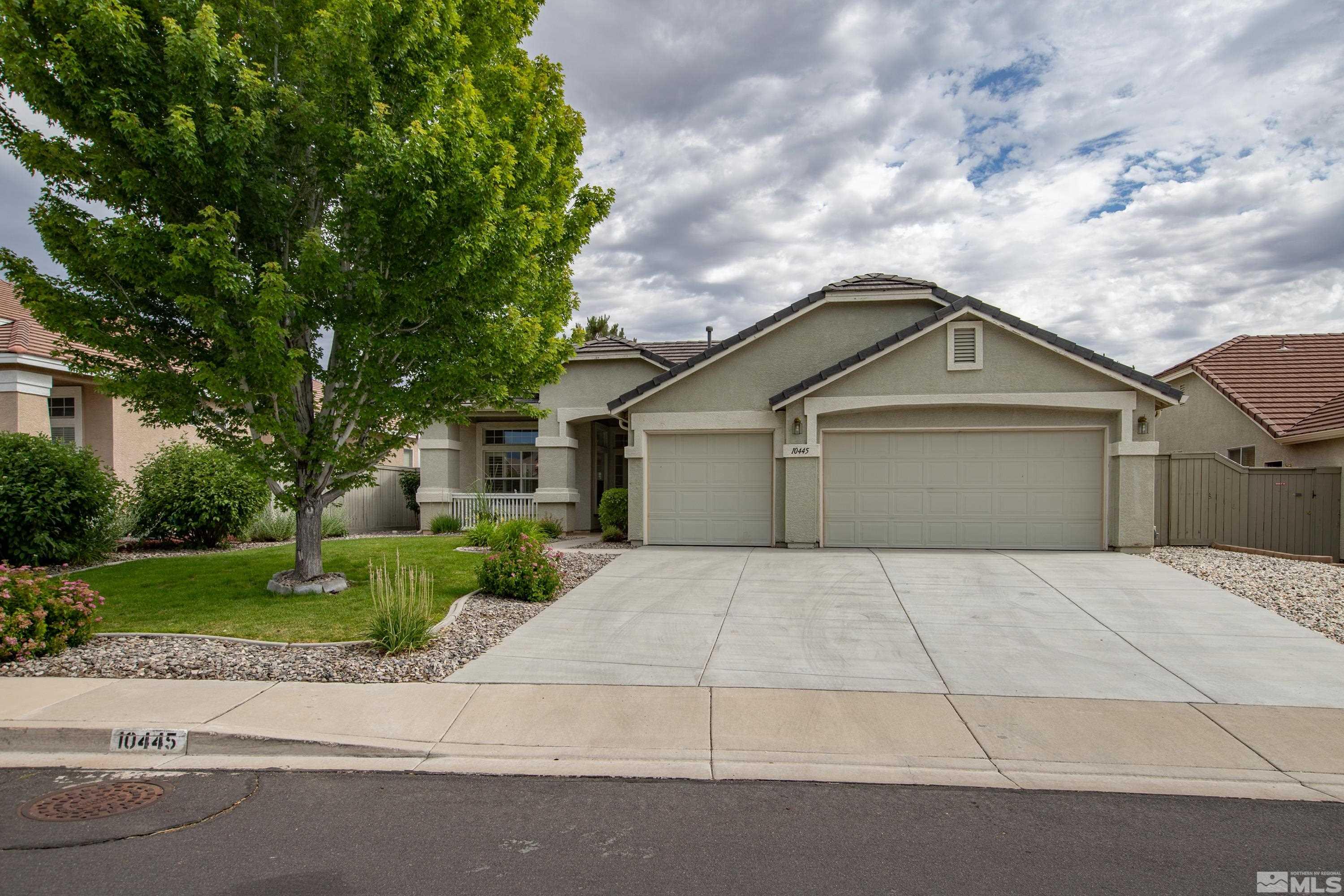 10445 Arbor Way Reno, NV 89521 - Photo 4 of 39 a front view of a house with a yard and garage