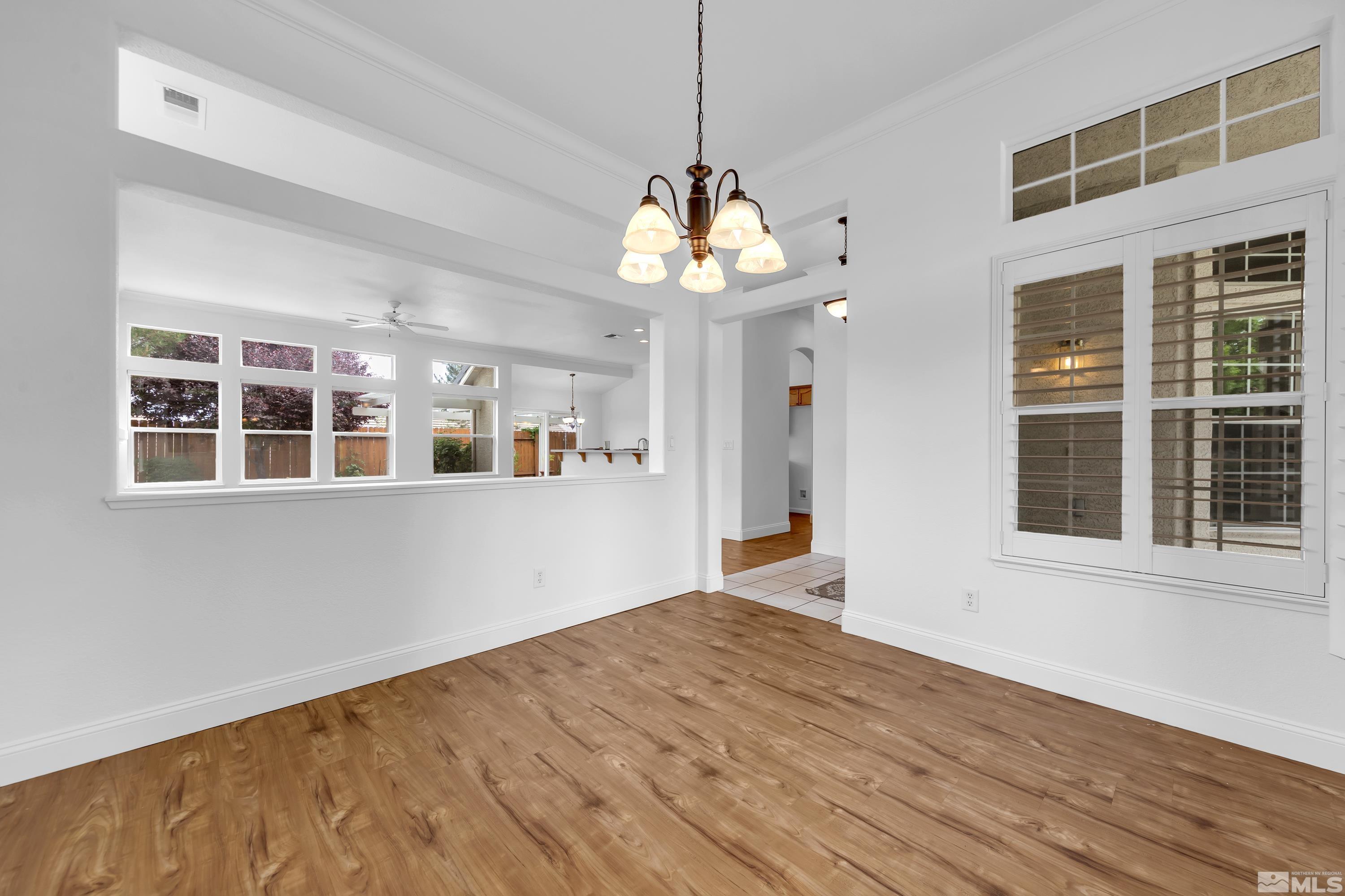 10445 Arbor Way Reno, NV 89521 - Photo 5 of 39 a view of an empty room with window and wooden floor