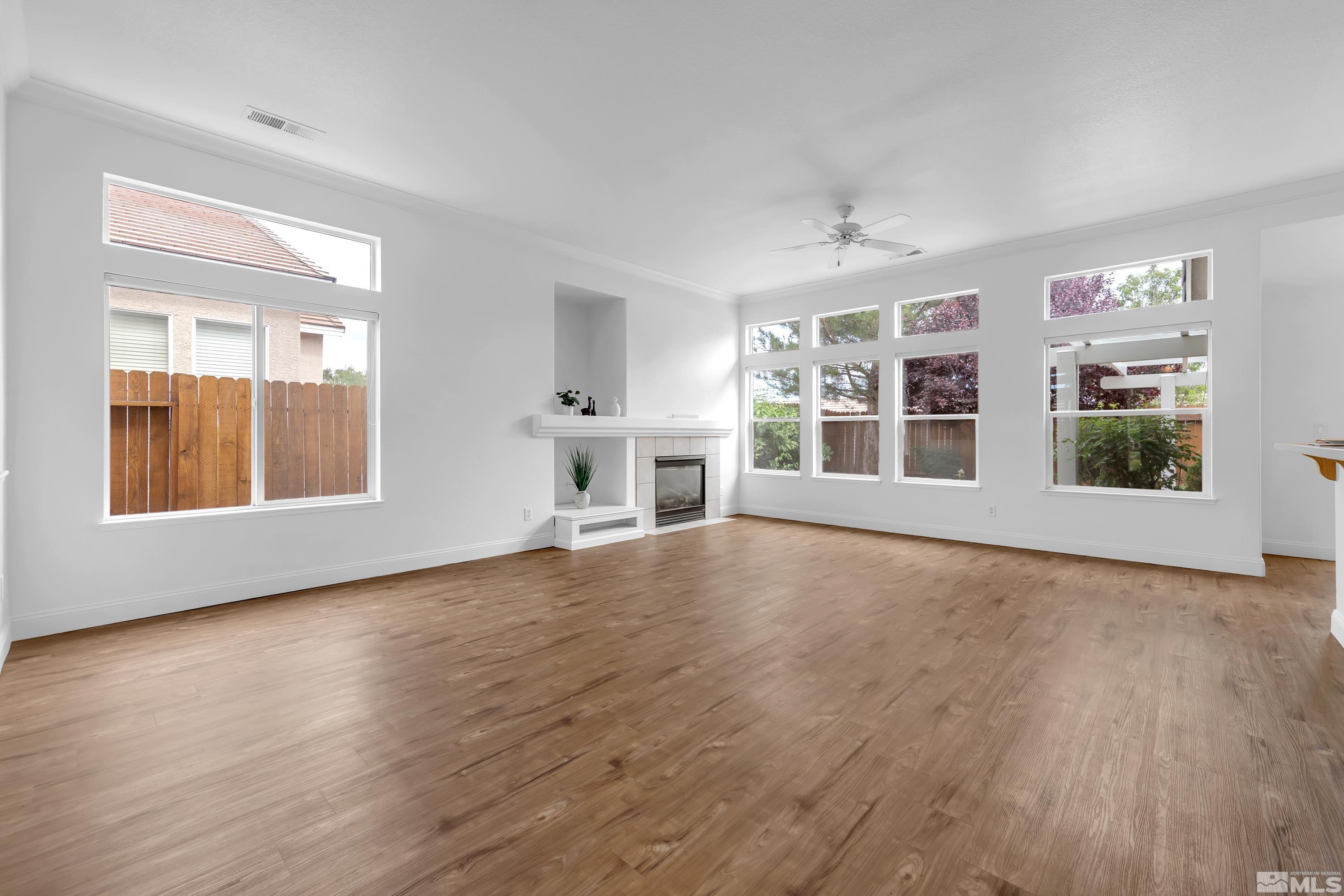 10445 Arbor Way Reno, NV 89521 - Photo 7 of 39 a view of an empty room with window and wooden floor