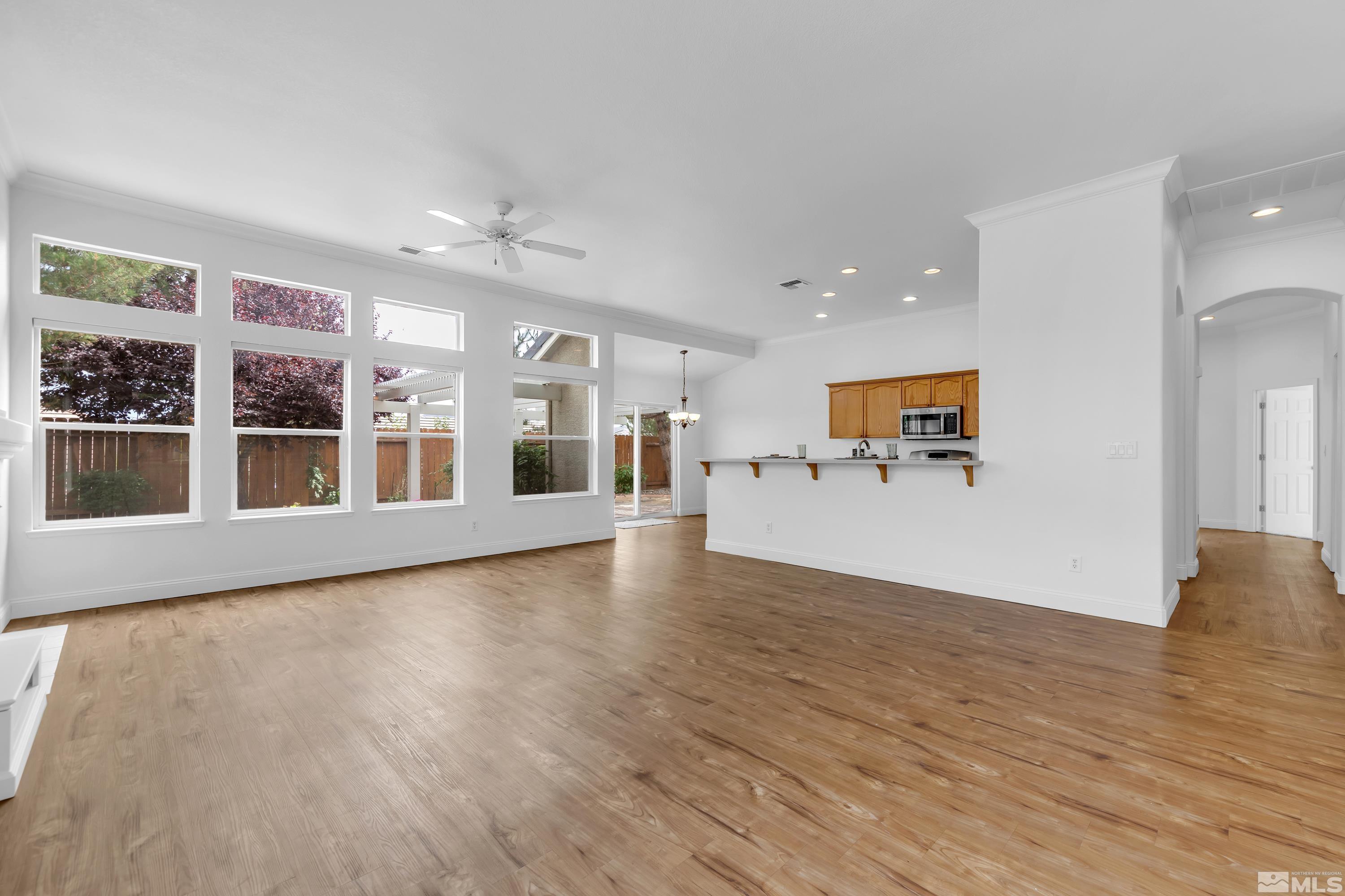 10445 Arbor Way Reno, NV 89521 - Photo 8 of 39 a view of a big room with wooden floor and windows