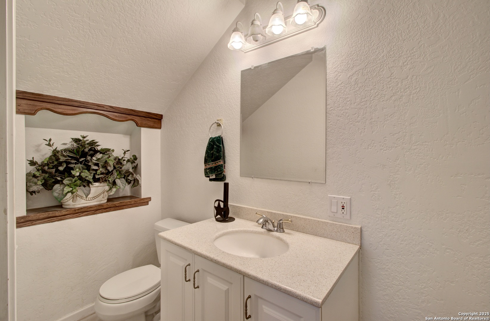6248 Yorkshire Drive Spring Branch, TX 78070 - Photo 19 of 28 a bathroom with a toilet sink and mirror