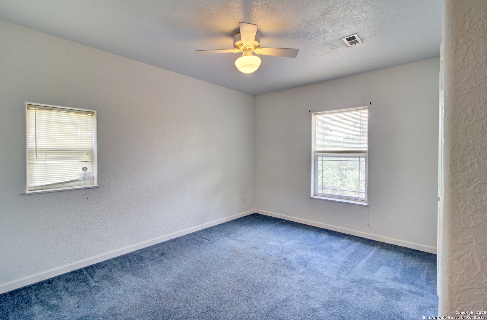 6248 Yorkshire Drive Spring Branch, TX 78070 - Photo 22 of 28 an empty room with window and chandelier fan