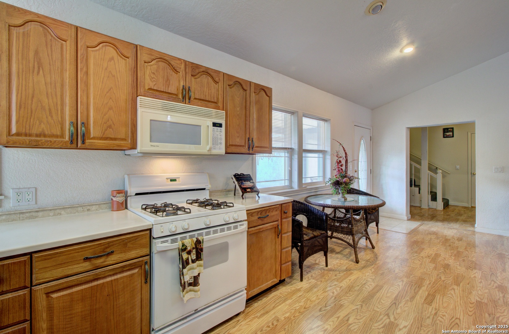 6248 Yorkshire Drive Spring Branch, TX 78070 - Photo 6 of 28 a kitchen with stainless steel appliances a stove a sink cabinets and a wooden floor