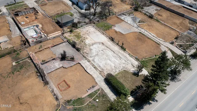 an aerial view of a house with a yard