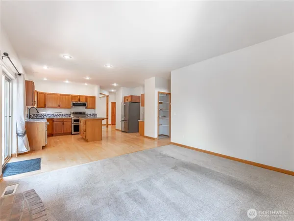 a big room with windows and fireplace