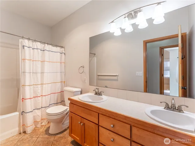 an empty room with a chair and a window