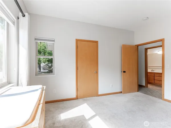 an empty room with a window and a dresser