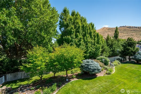 a view of a house with a yard and a garden