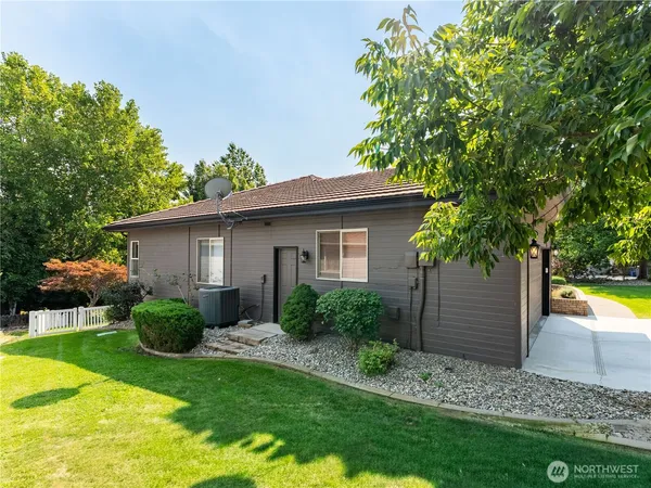 a wooden fence with some plants and trees