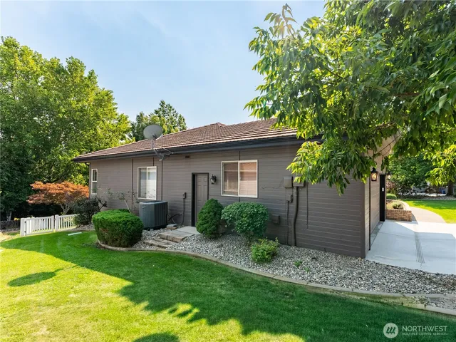 a wooden fence with some plants and trees