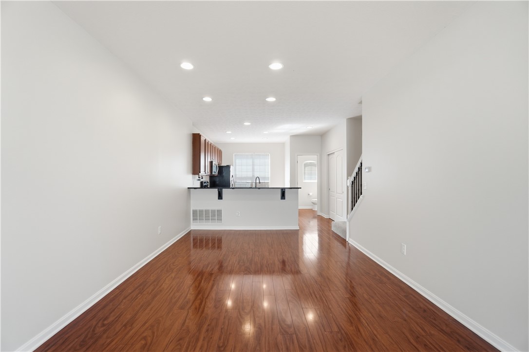 4294 Straight Arrow Road Dayton, OH 45430 - Photo 11 of 41 This open concept living area boasts rich hardwood flooring, creating an inviting and seamless flow.