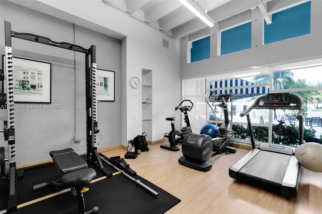 a room with gym equipment and a large window