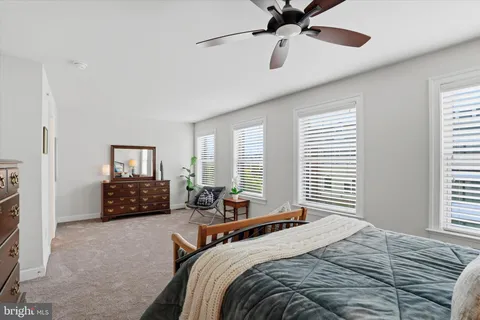 a bedroom with a bed dresser and a window