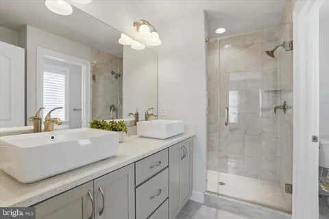 a bathroom with a sink double vanity and a mirror