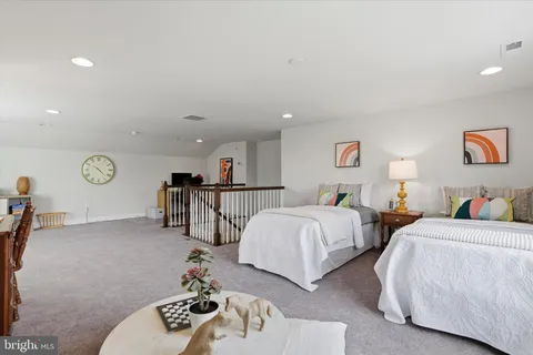 a spacious bedroom with two beds and a chandelier