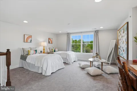 a spacious bedroom with two beds and large windows