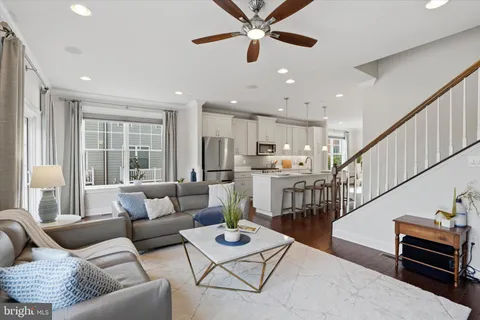 a living room with furniture and kitchen view