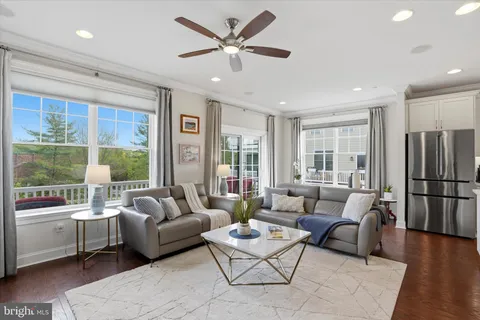 a living room with furniture and a large window with outer view