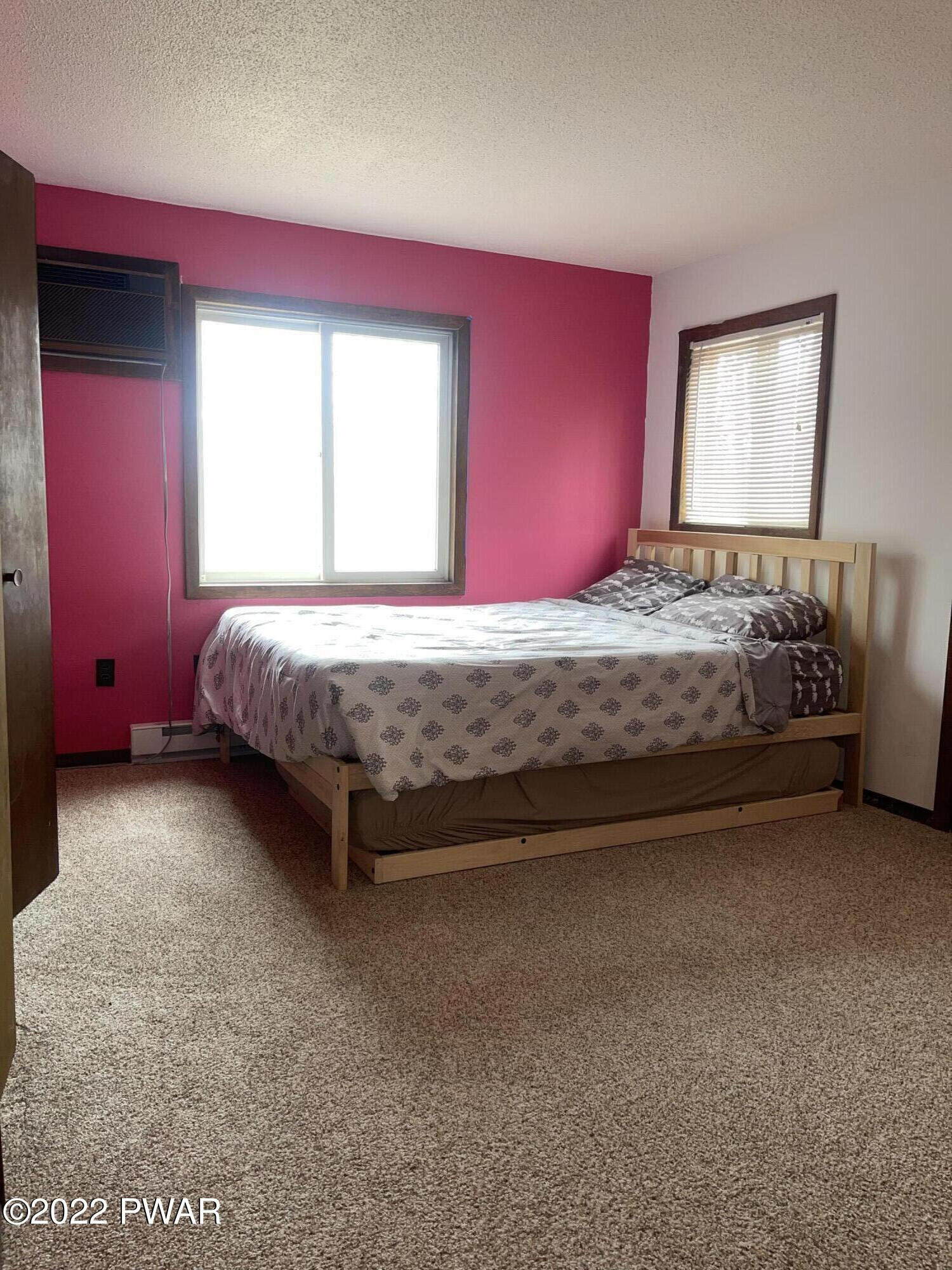 149 Rodeo Drive Hawley, PA 18428 - Photo 12 of 34 a bed sitting in a bedroom next to a window