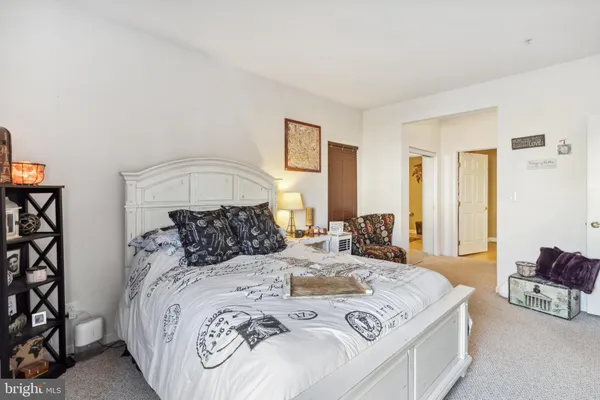 a bedroom with a large bed and a chandelier