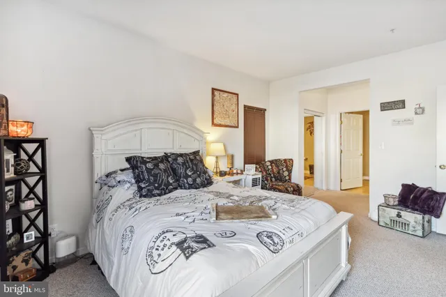 a bedroom with a large bed and a chandelier