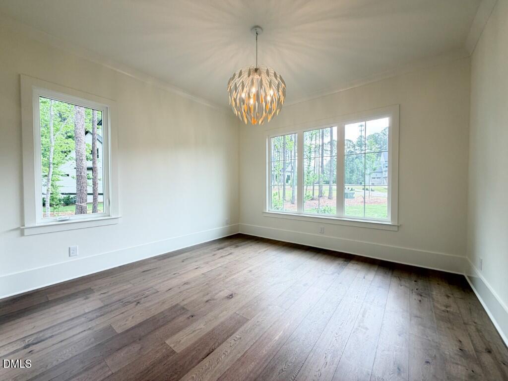 7441 Summer Tanager Trail Raleigh, NC 27614 - Photo 16 of 48 a view of an empty room with wooden floor and a window