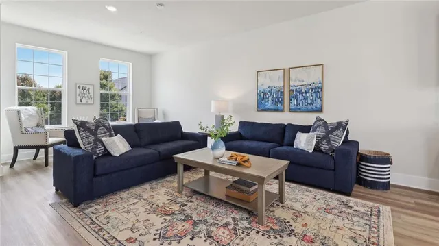 a living room with furniture lamp and window