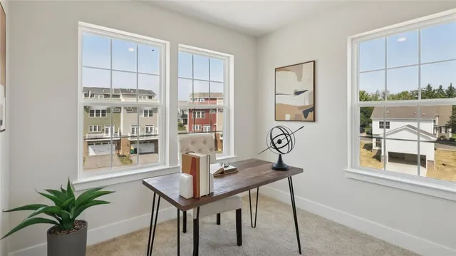 a view of a workspace with furniture and a potted plant