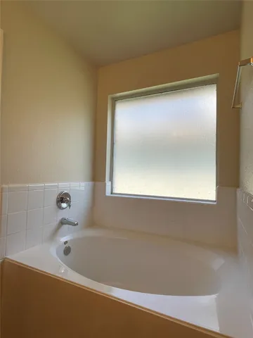 a bathroom with a glass shower door
