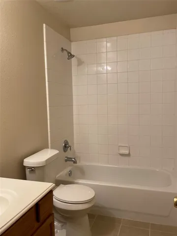 a white toilet sitting next to a white tub