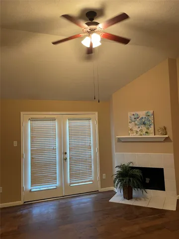 a view of a room with wooden floor and windows