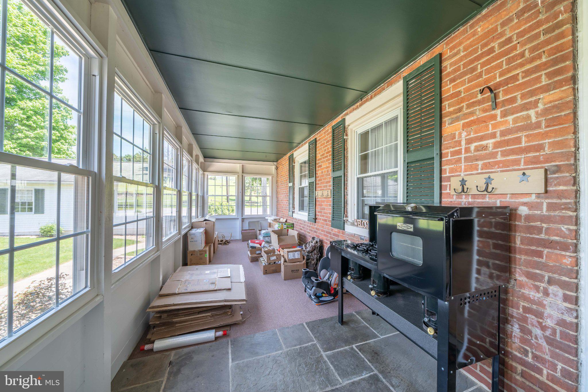 340 Applehouse Road Belleville, PA 17004 - Photo 49 of 76 Charming sunlit porch with brick accents.