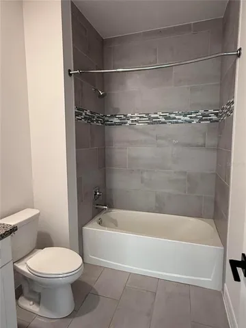 a white bath tub sitting next to a toilet