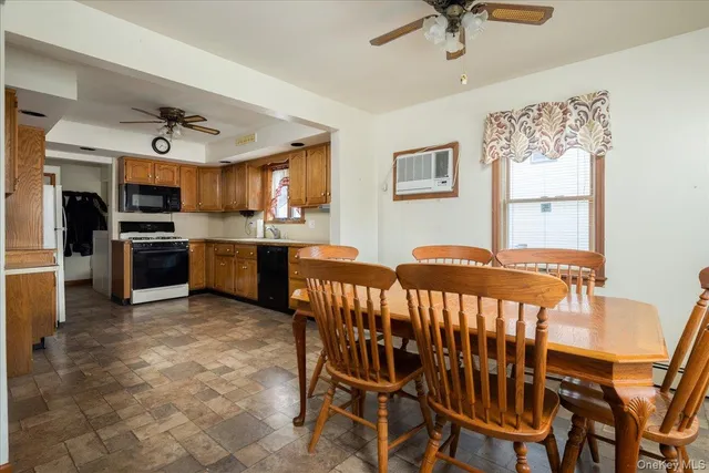 a view of a kitchen with a dining table chairs and stainless steel appliances
