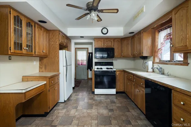 a kitchen with stainless steel appliances a sink cabinets and a window