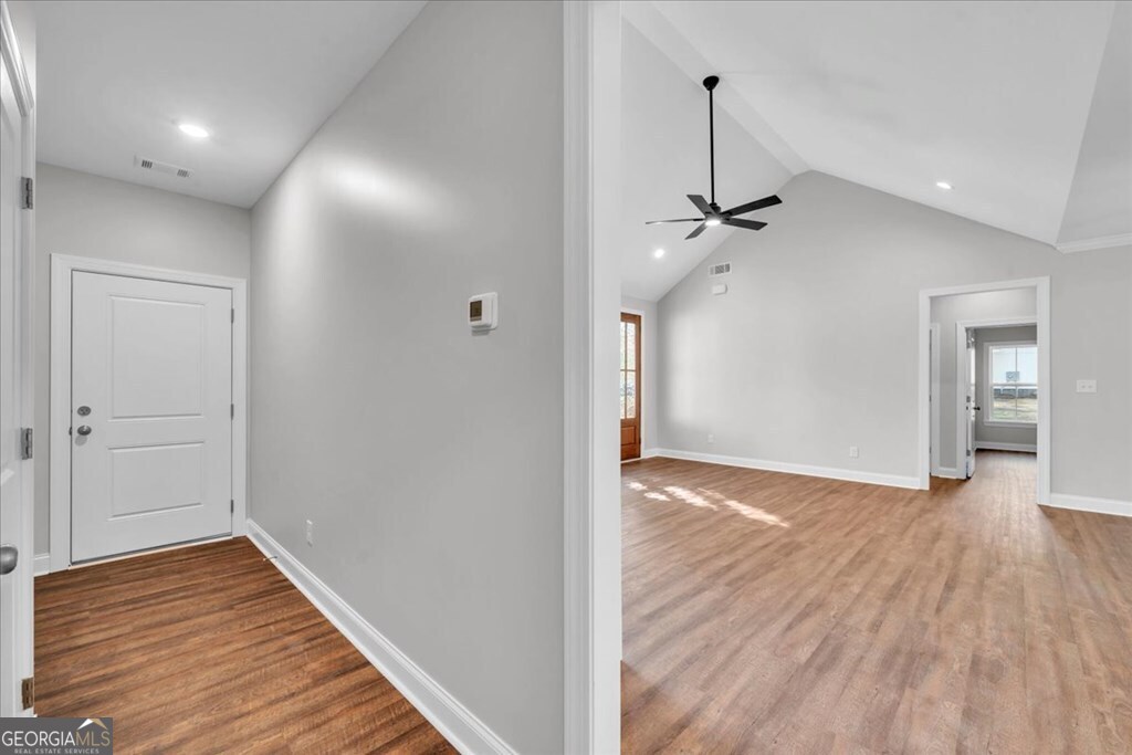 2767 Claxton Dairy Road Dublin, GA 31021 - Photo 20 of 51 a view of a room with wooden floor and a ceiling fan