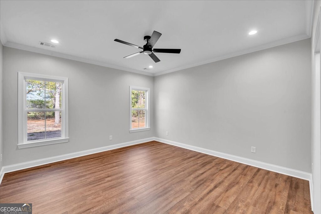 2767 Claxton Dairy Road Dublin, GA 31021 - Photo 21 of 51 a view of an empty room with wooden floor and a window