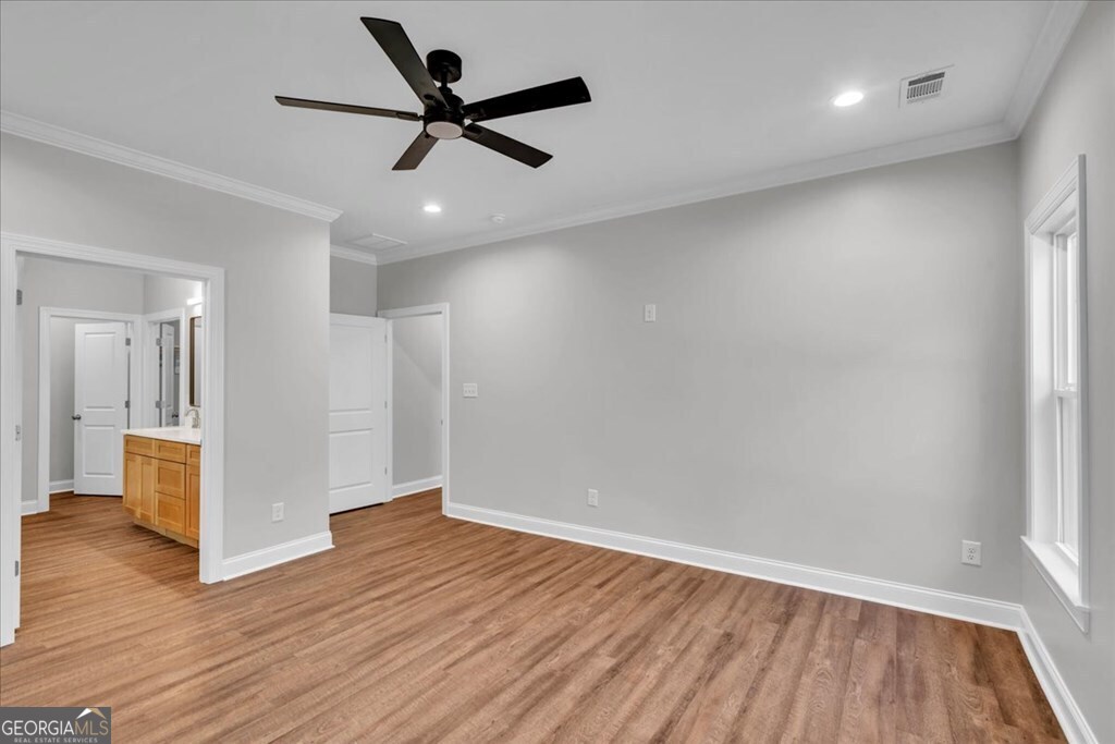 2767 Claxton Dairy Road Dublin, GA 31021 - Photo 23 of 51 an empty room with wooden floor and a ceiling fan