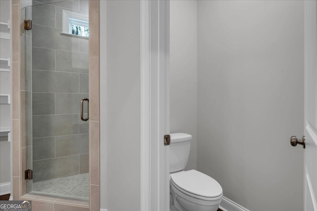 2767 Claxton Dairy Road Dublin, GA 31021 - Photo 27 of 51 a white toilet sitting next to a shower