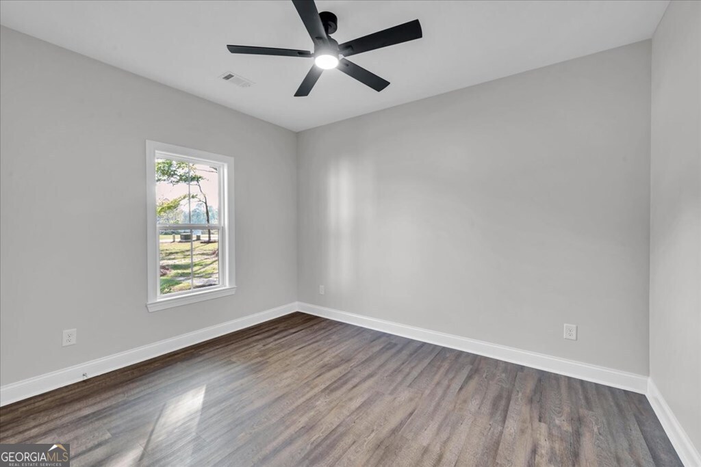 2767 Claxton Dairy Road Dublin, GA 31021 - Photo 30 of 51 an empty room with wooden floor and windows