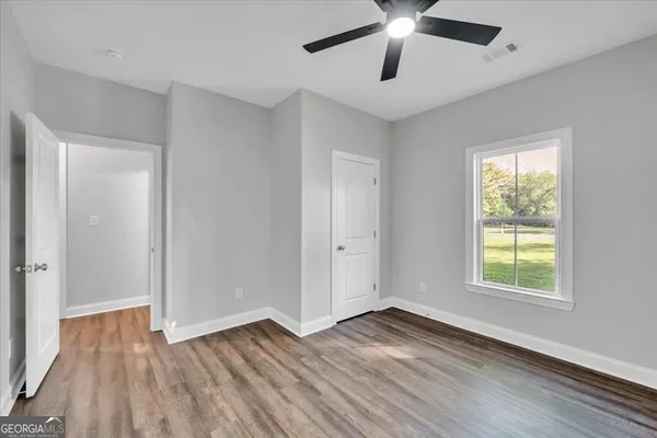 wooden floor in an empty room with a window