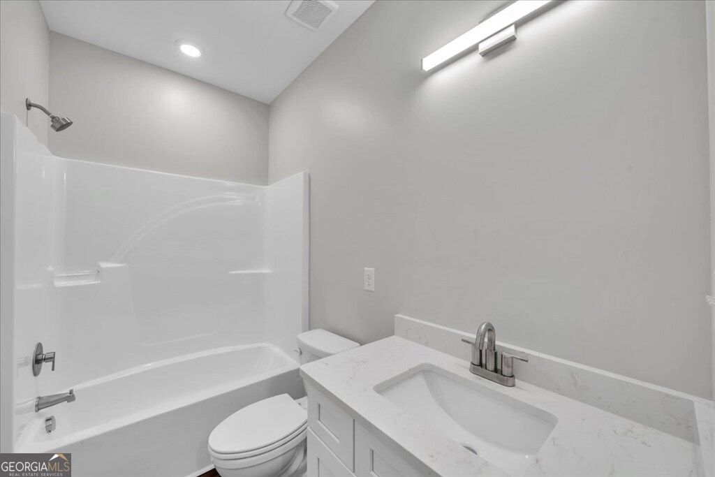 2767 Claxton Dairy Road Dublin, GA 31021 - Photo 34 of 51 a bathroom with a sink toilet and a bathtub