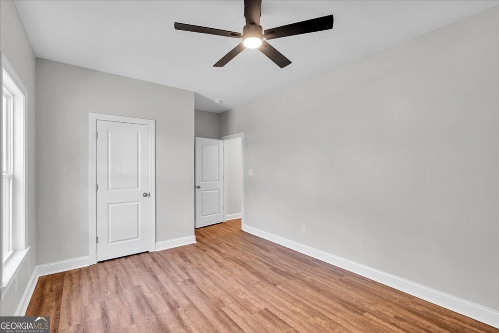 2767 Claxton Dairy Road Dublin, GA 31021 - Photo 37 of 51 wooden floor in an empty room with a window