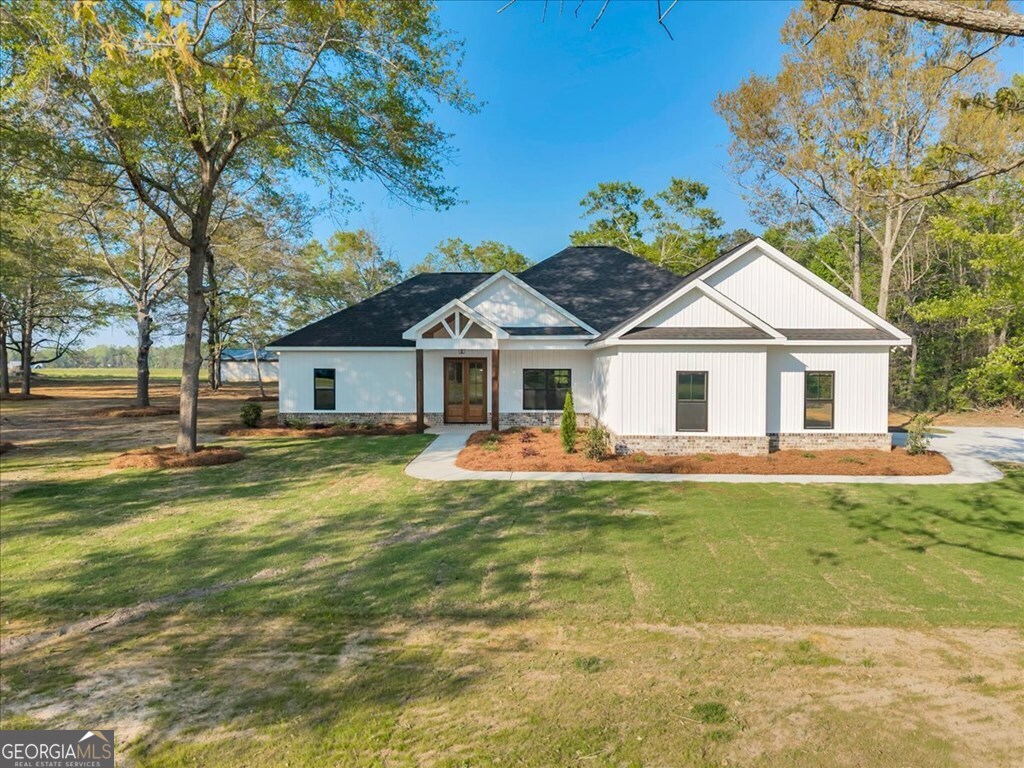 2767 Claxton Dairy Road Dublin, GA 31021 - Photo 43 of 51 a view of a house with swimming pool and a yard