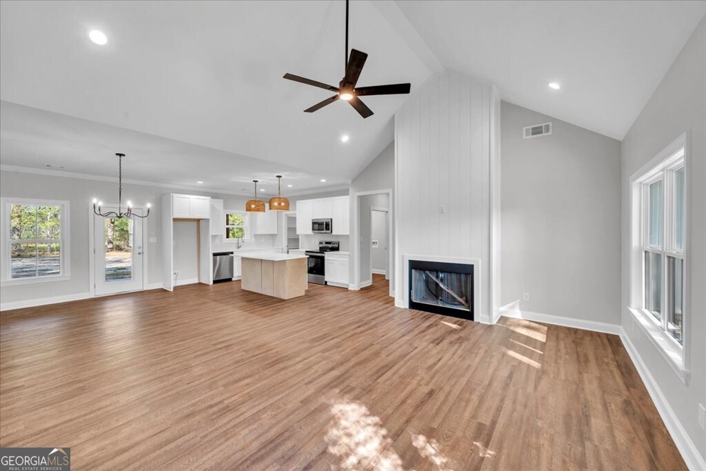 2767 Claxton Dairy Road Dublin, GA 31021 - Photo 5 of 51 a view of a room with kitchen and fireplace wooden floor